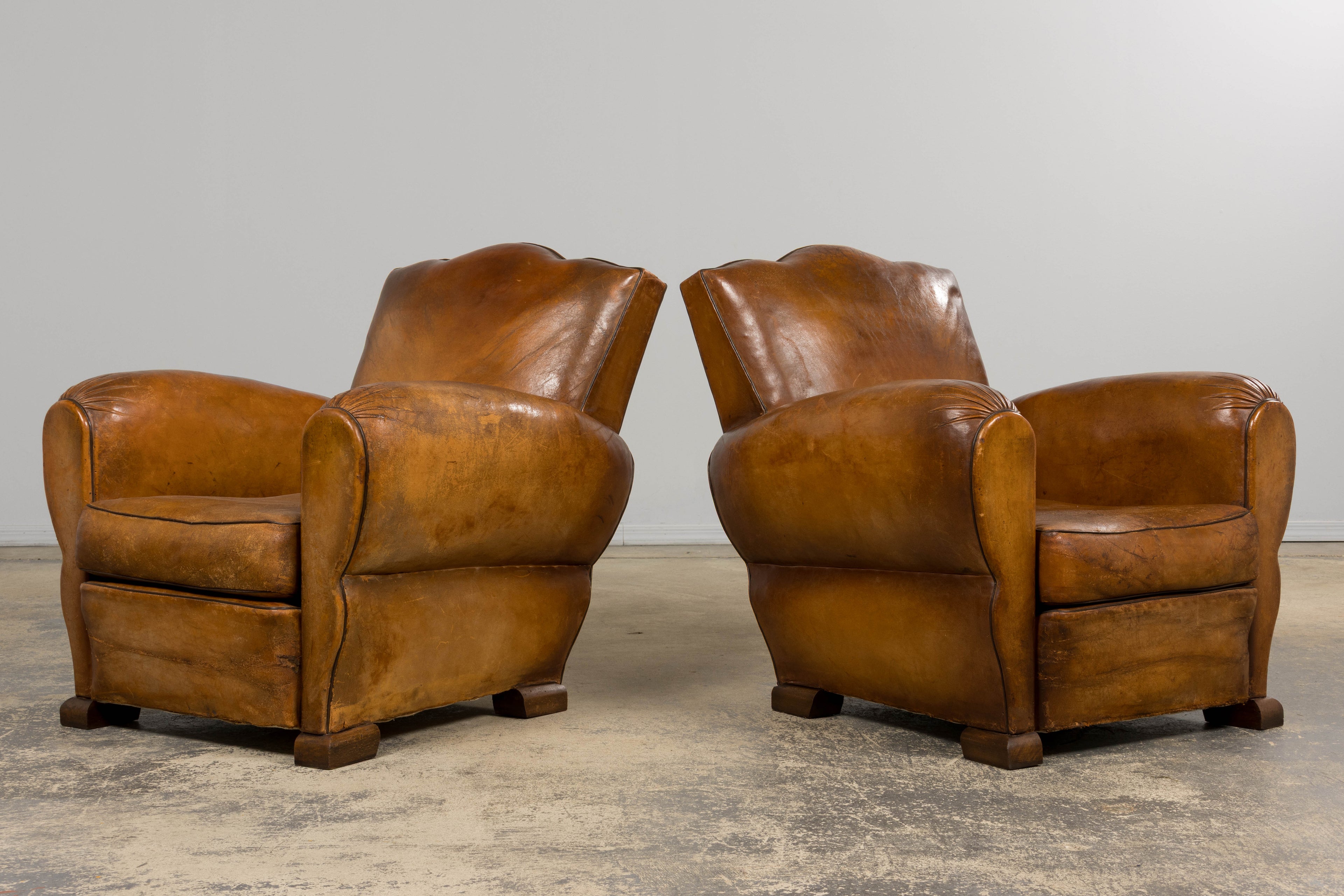 ON HOLD 1920s French Art Deco Scalloped Back Club Chairs in Caramel Leather – A Pair