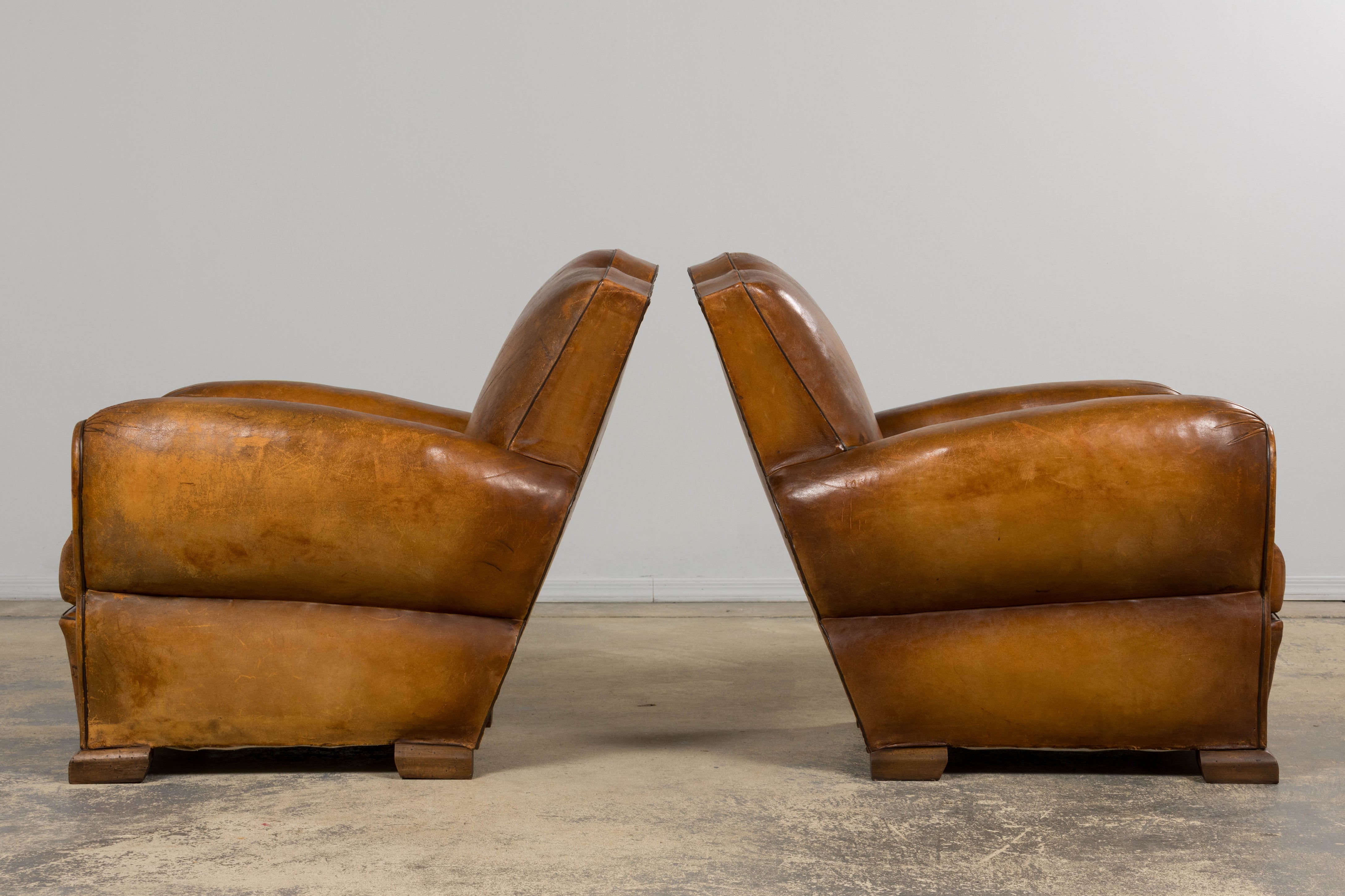 1920s French Art Deco Scalloped Back Club Chairs in Caramel Leather – A Pair