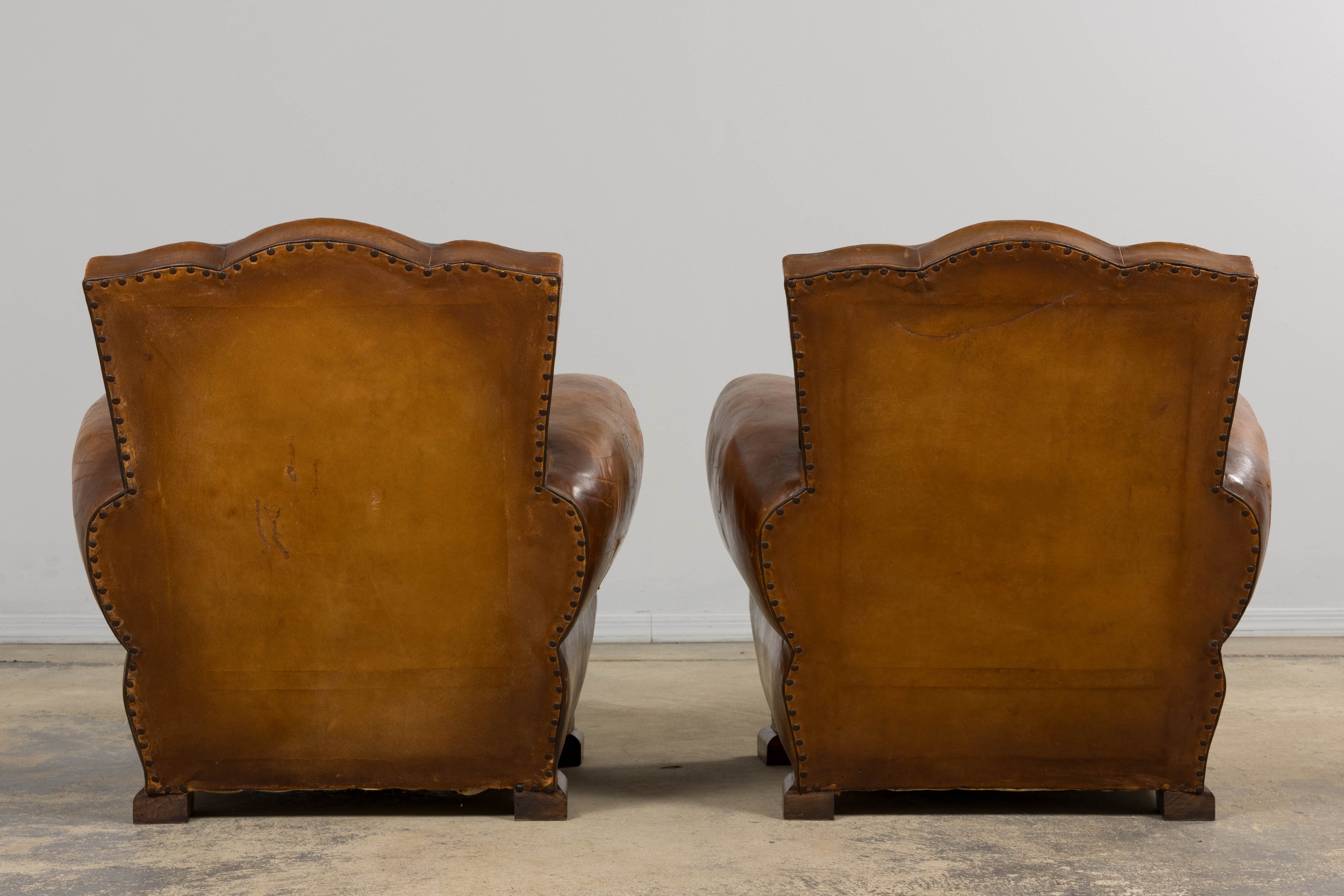 ON HOLD 1920s French Art Deco Scalloped Back Club Chairs in Caramel Leather – A Pair