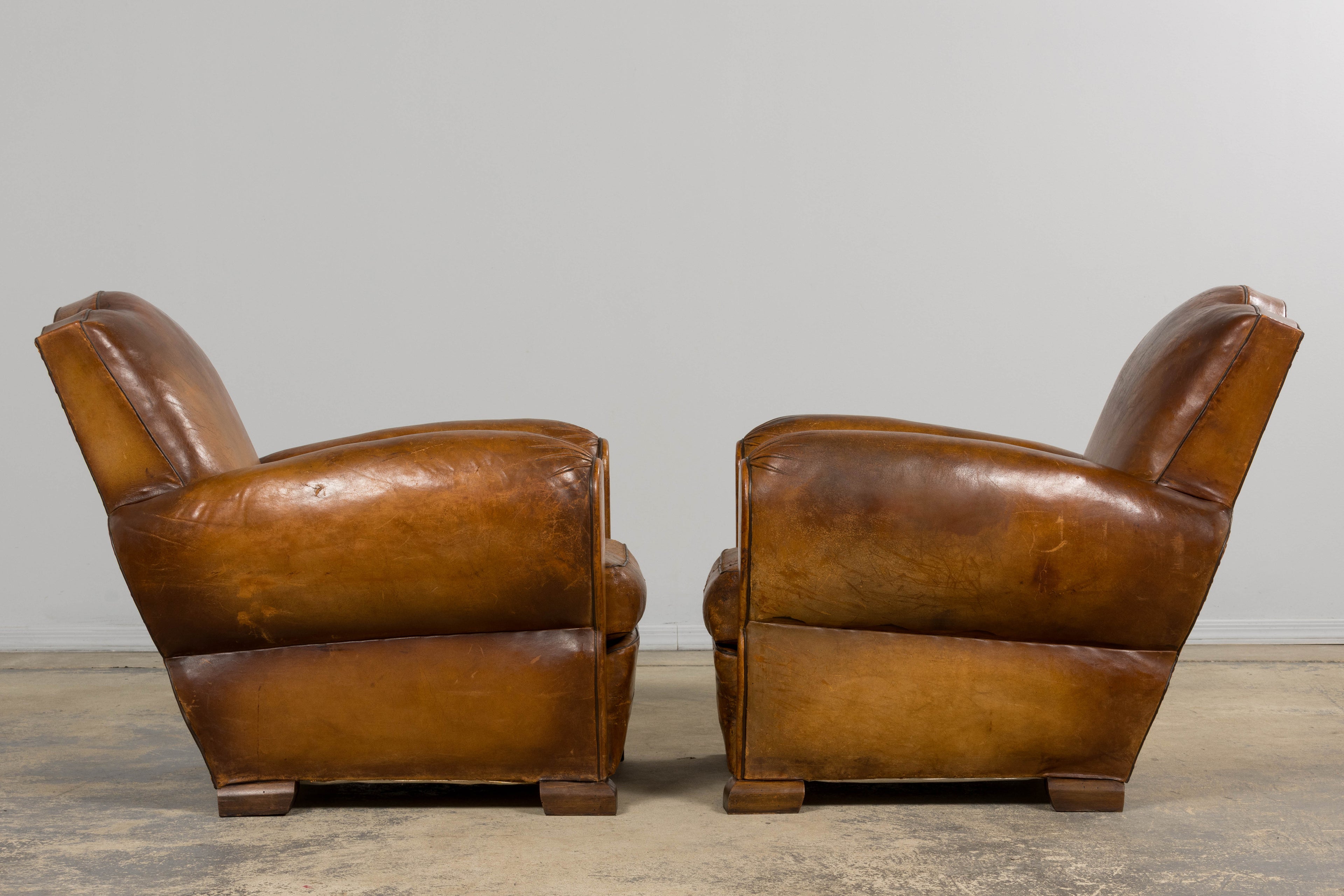 ON HOLD 1920s French Art Deco Scalloped Back Club Chairs in Caramel Leather – A Pair