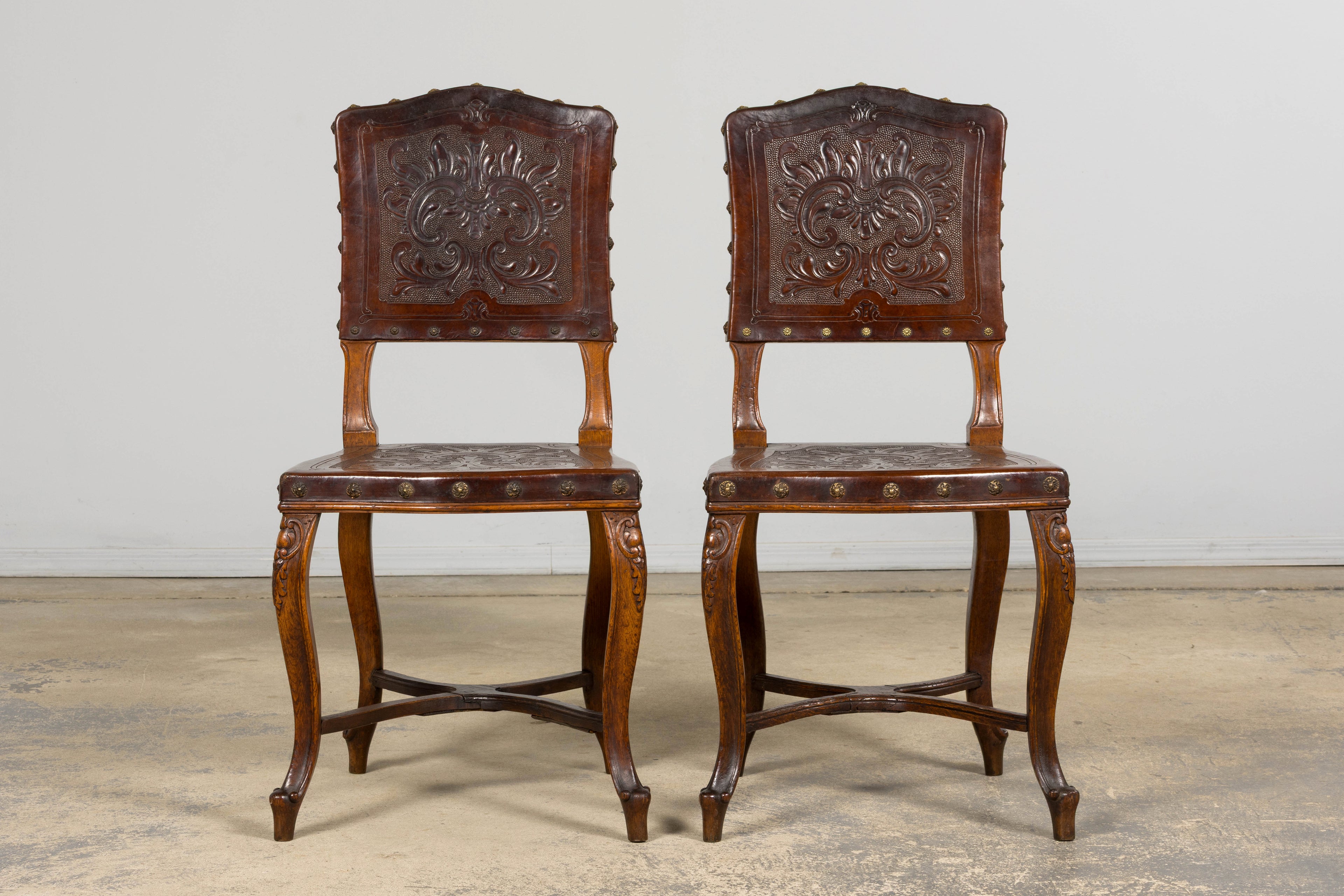 Set of 12 Late 19th Century French Renaissance Revival Carved Oak Dining Chairs with Embossed Leather