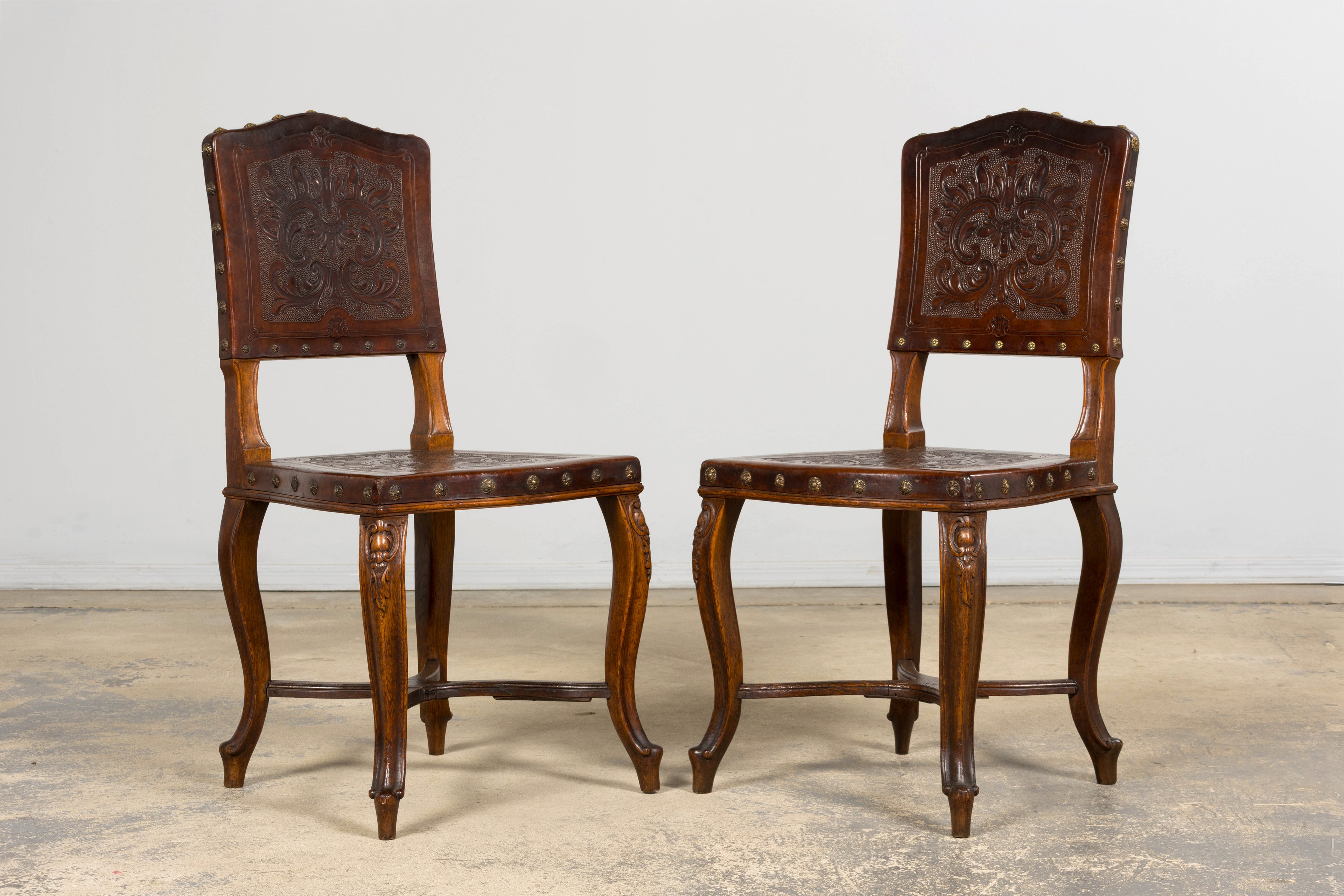 Set of 12 Late 19th Century French Renaissance Revival Carved Oak Dining Chairs with Embossed Leather