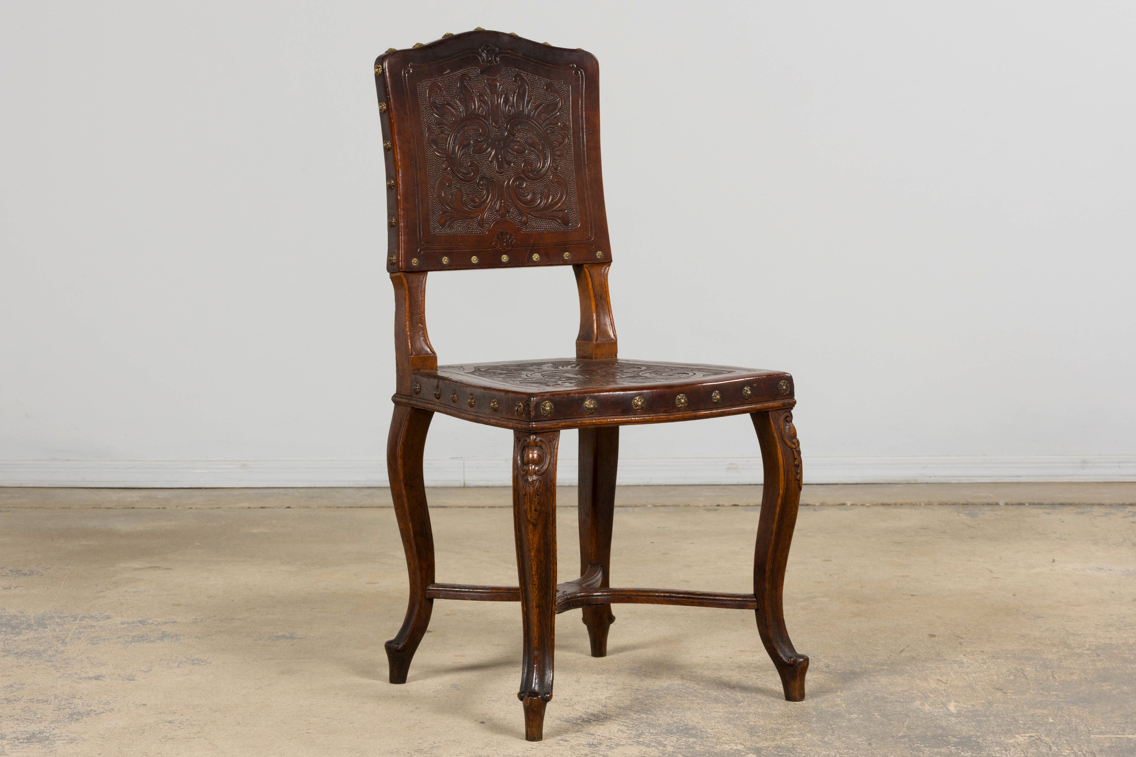 Set of 12 Late 19th Century French Renaissance Revival Carved Oak Dining Chairs with Embossed Leather