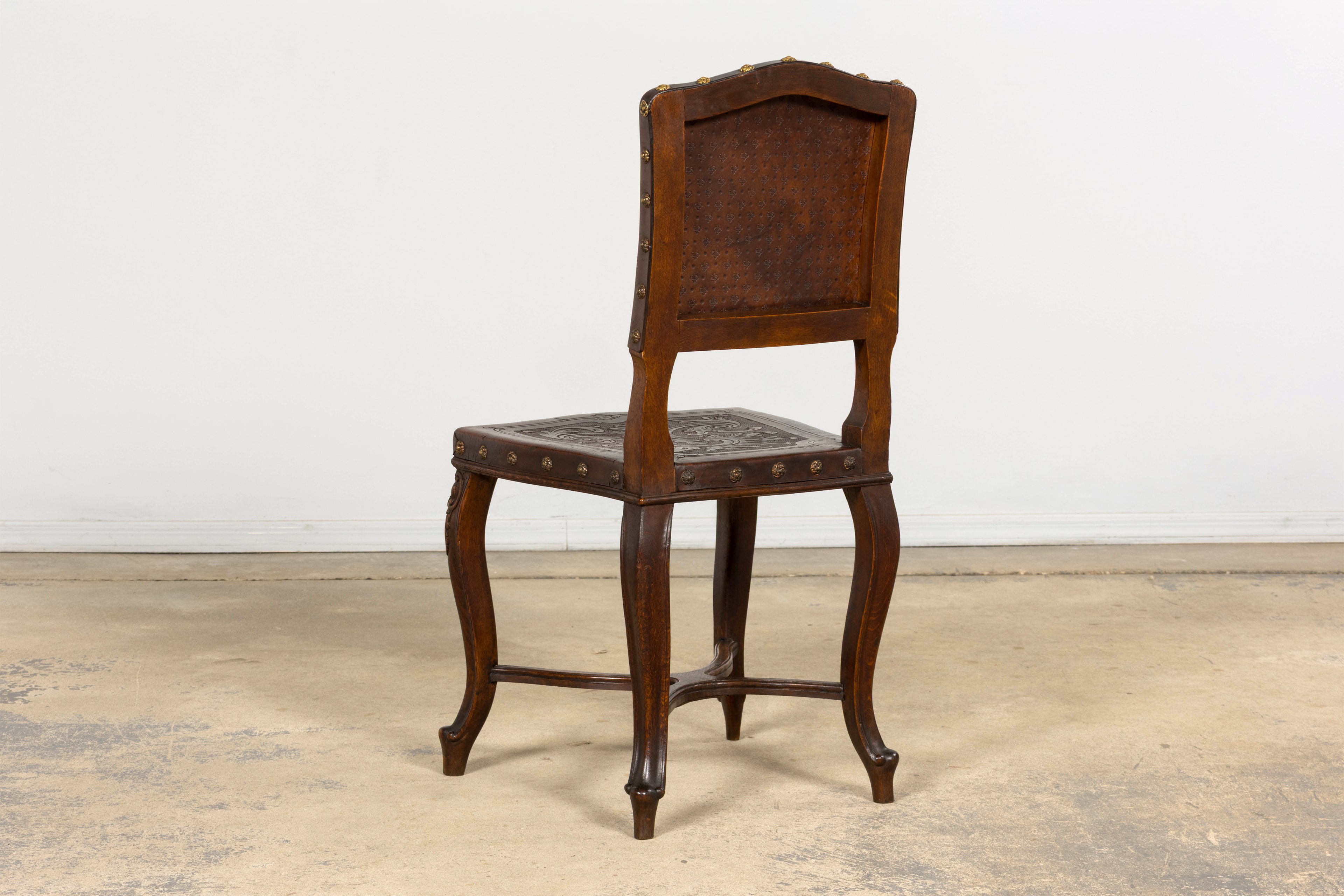 Set of 12 Late 19th Century French Renaissance Revival Carved Oak Dining Chairs with Embossed Leather