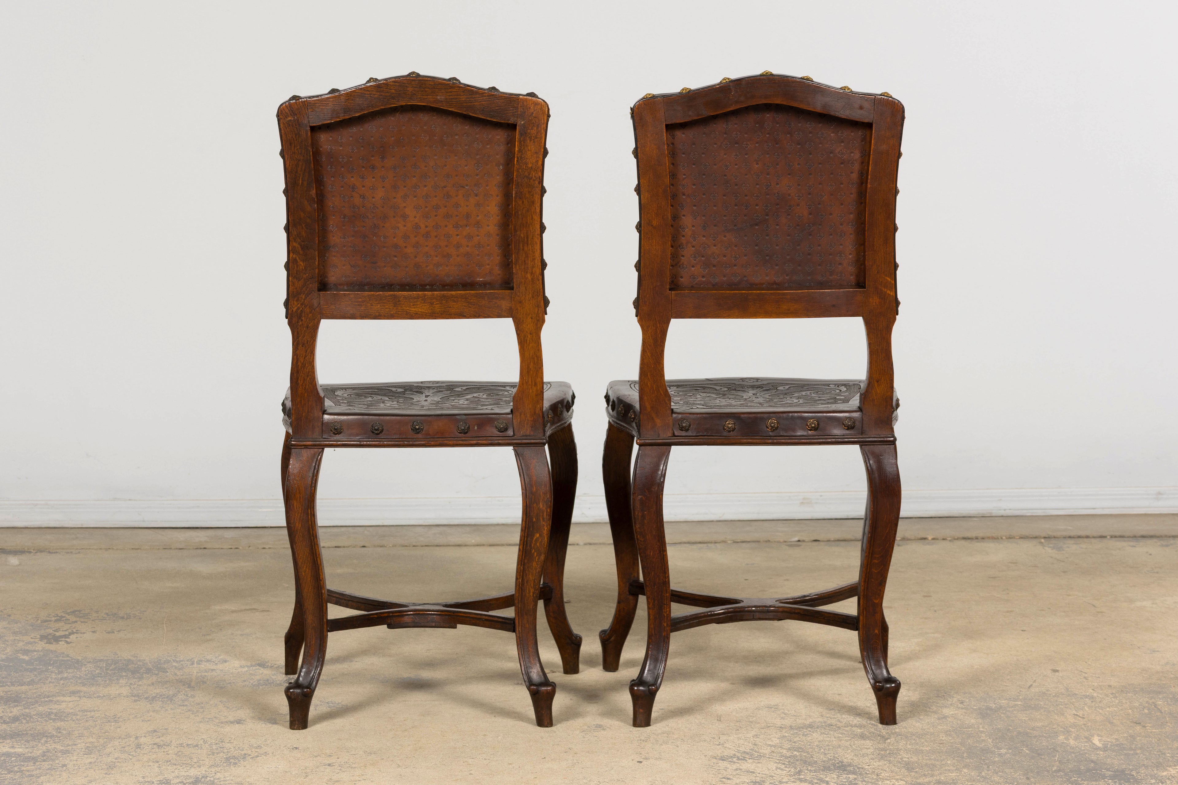 Set of 12 Late 19th Century French Renaissance Revival Carved Oak Dining Chairs with Embossed Leather